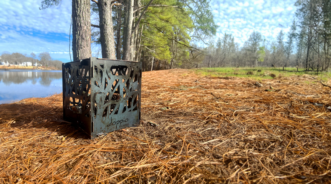 Portable Fire Pit set up in the woods by a river