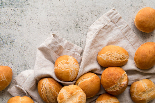 pile of sourdough bread rolls on a light background