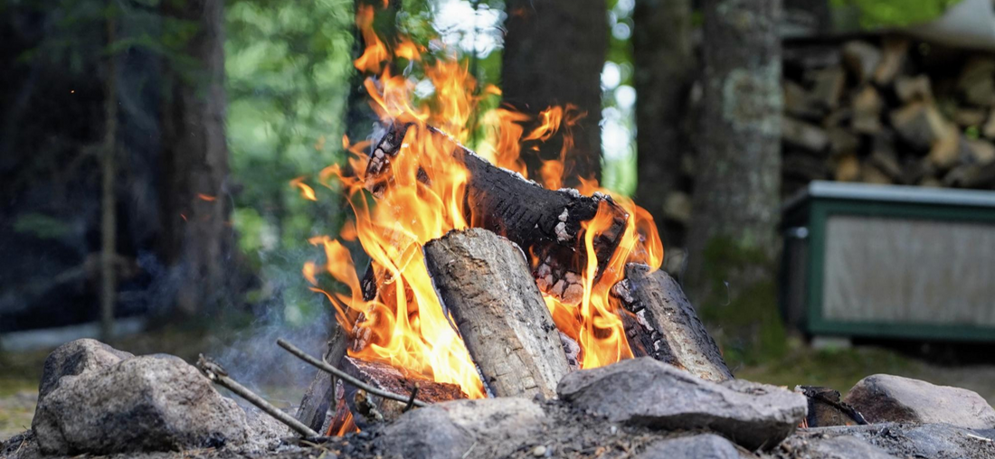 Campfire blazing in the middle of the camp