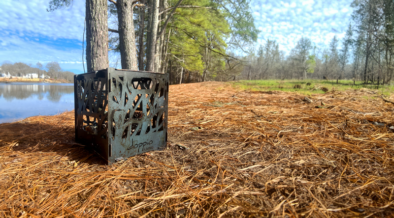 Portable Fire Pit set up in the woods by a river