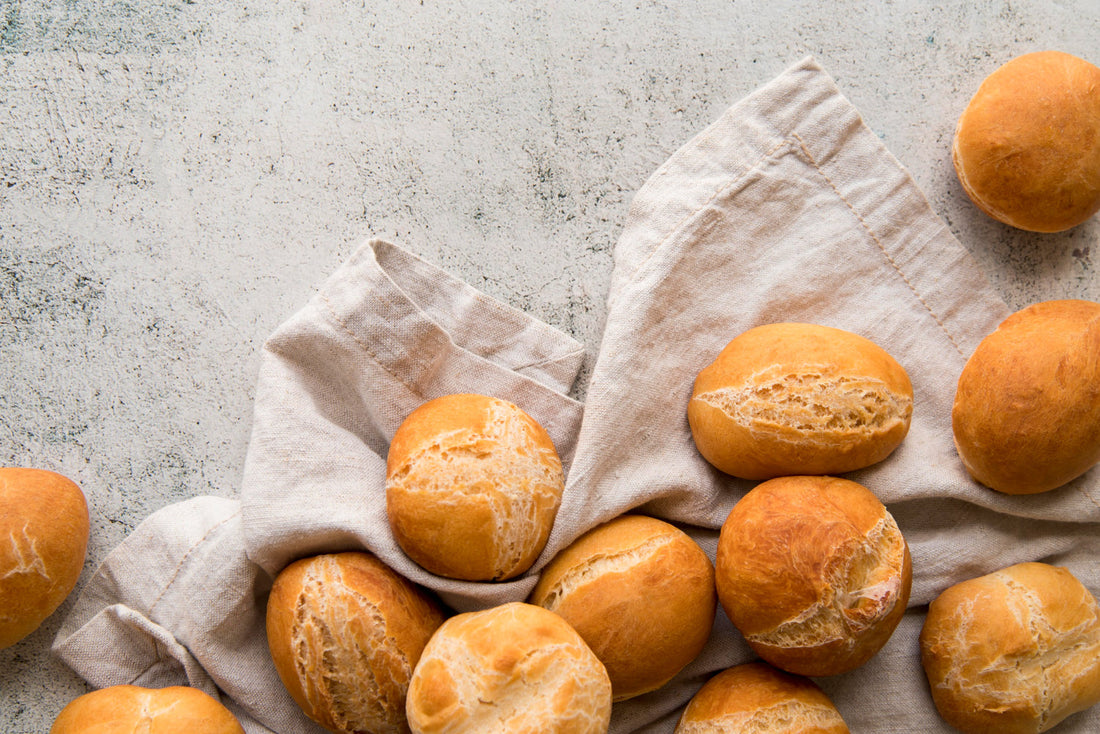pile of sourdough bread rolls on a light background
