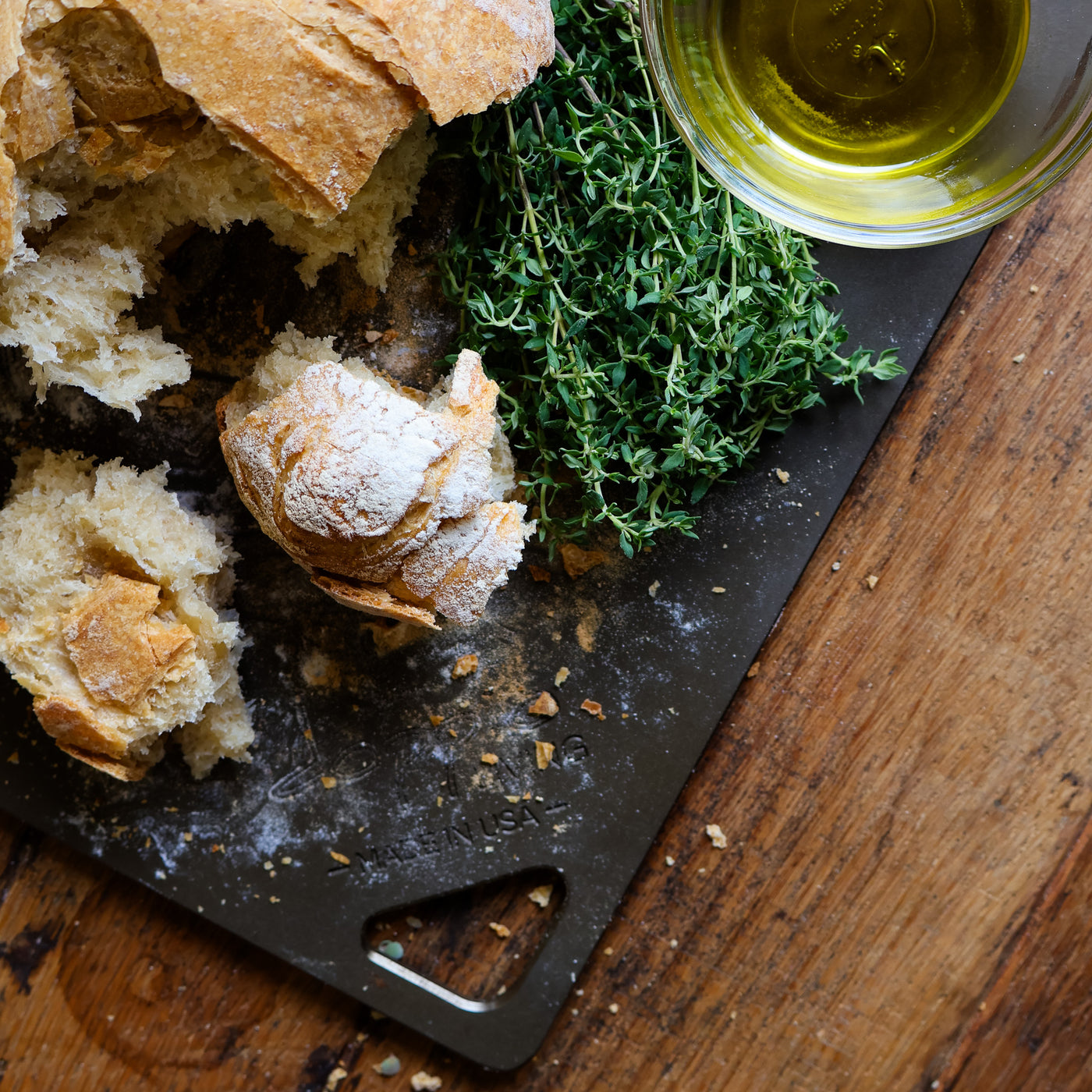 Artisan bread on a pizza steel with crispy crust and flour-dusted surface on carbon steel